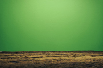 Fototapete - Beautiful old oak wooden table and green wall background.