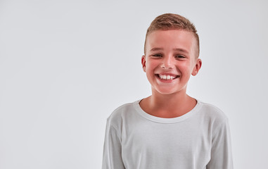 Cute boy on a gray background