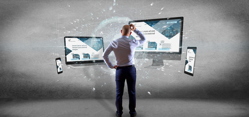 Poster - Businessman in front of Devices connected to a global business network 3d rendering