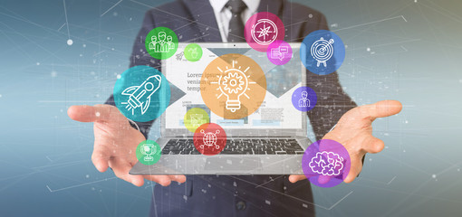 Poster - businessman holding a cloud of colorfull start up icon bubble with a laptop 3d rendering