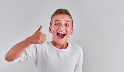 Wall Mural - Cute boy on a gray background