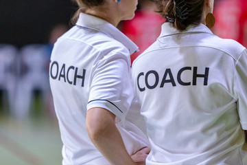 Wall Mural - Female coaches in white COACH shirt