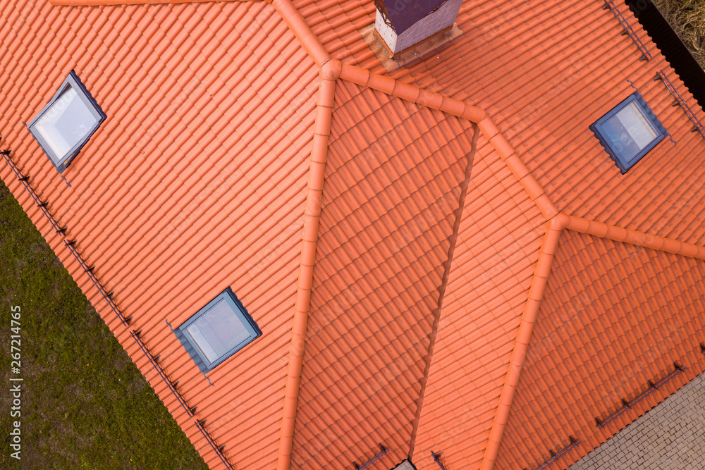 Aerial top view of house metal shingle roof, brick chimneys and small ...