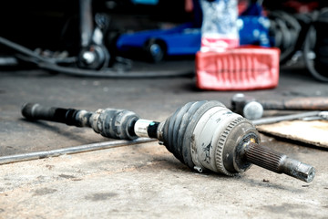 Wall Mural - Change the new drive shaft in the car.
