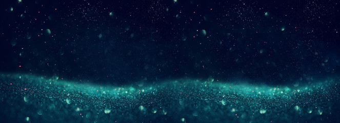 glitter vintage lights background. black, blue, green and silver. de-focused. banner