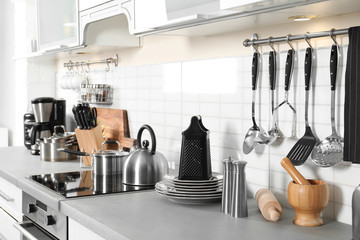 Sticker - Different appliances, clean dishes and utensils on kitchen counter