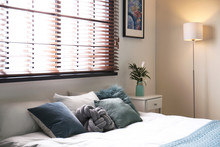Modern Room Interior With Comfortable Double Bed And Window Blinds