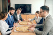 © Dusan Petkovic - Business people sitting at boardroom and having pizza for lunch.