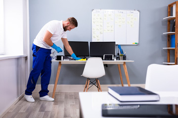 Wall Mural - Janitor cleaning white desk in office