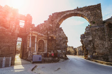 The Ruins Of The Central Gate Of The Ancient City Of Side In Turkey In The Light Of The Setting Sun.