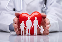 Doctor Protecting Family Cut Out And Heart Shape