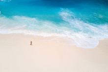 Top View From Aerial. Bali Drone Shoot With Ocean Waves And White Sand. People Walk On Beach