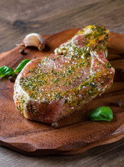 Raw Pork Loin chops marinated meat Steak for bbq on wooden table background