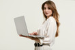 © micro - Gorgeous brunette model posing in white clothes with laptop