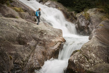 Woman Hiker Standing On Boulder Near Strong River Stream In High Tatras