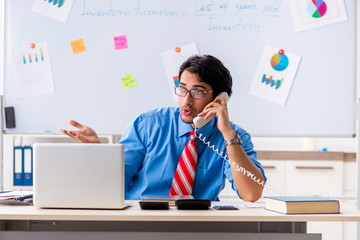 Young male financial manager working in the office 