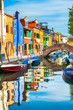 Colorful houses on the canal in Burano island, Venice, Italy.