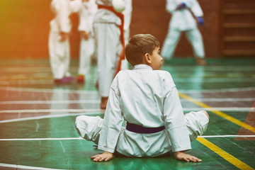 young karate boy warming up in a kimono