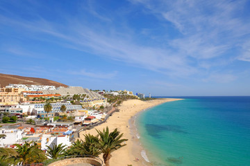 Wall Mural - View from above on beach with golden sand and ocean in Morro Jable, Fuerteventura.