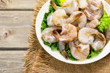 Large Raw Shrimp on Wooden Background. Selective focus.