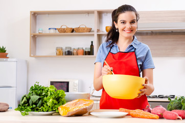 Young woman with vegetables in the kitchen 