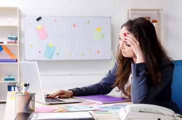 Young female designer working in the office 