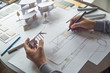 © Chaosamran_Studio - architect design working drawing sketch plans blueprints and making architectural construction model in architect studio