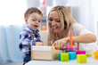© Oksana Kuzmina - Cute child and mother playing with toys at home. Little toddler boy having fun pastime in nursery.