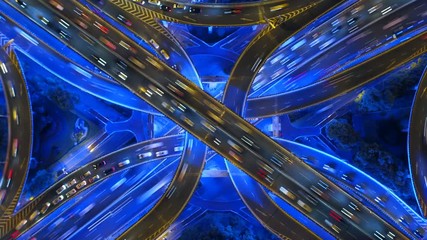 Aufkleber - Time lapse of aerial view of highway junctions shape letter x cross at night. Bridges, roads, or streets in connection or transportation concept in urban city, Shanghai Downtown, China.