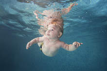 Little Baby Boy Learning To Swim Underwater In A Swimming Pool. Healthy Family Lifestyle And Children Water Sports Activity. Child Development, Disease Prevention