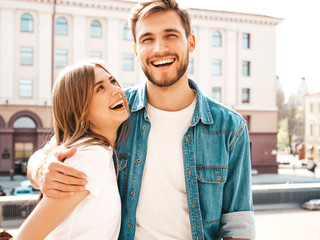 Smiling beautiful girl and her handsome boyfriend in casual summer clothes. Happy cheerful family having fun on the street background in sunglasses.