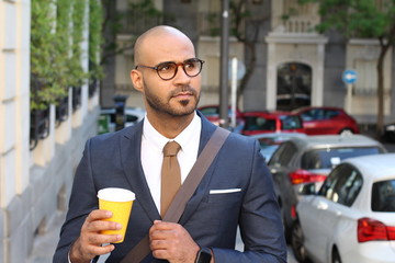 Confident stylish businessman walking outdoors 