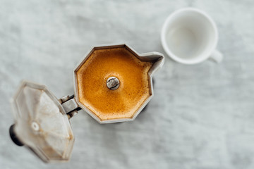 Moka pot with coffee and cup