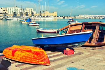 Wall Mural - Fishing boats in the old harbor of Bari on the Adriatic sea coast, Puglia region, Italy. 