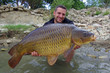 © sablin - Happy fisherman holding a  big common carp. Freshwater fishing
