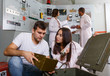 © JackF - Friends inspecting box with facilities in quest room