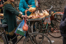 Female Vietnamese Butcher Cutting Raw Of Chicken On The Bicycle.