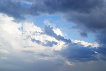 Wall Mural - white and gray clouds cover the last spot of blue sky before the storm. dramatic skyscape.