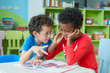 © weedezign - Two boy kid sit on table and coloring in book  in preschool library,Kindergarten school education concept