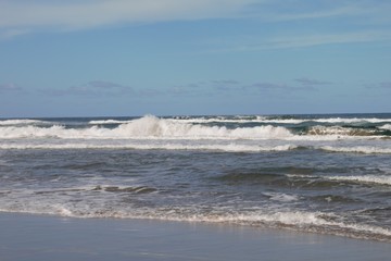 Wild white waves at the Australian beach invite for surfing 