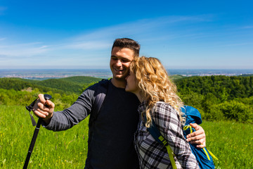 Portrait of young couple enjoying hiking together in nature.