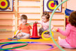© Oksana Kuzmina - Nursery babies toddlers group play with rings in gym