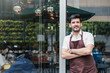 © paulaphoto - Startup successful small business owner man walking in his coffee shop or restaurant. Portrait of young caucasian man successful barista cafe owner