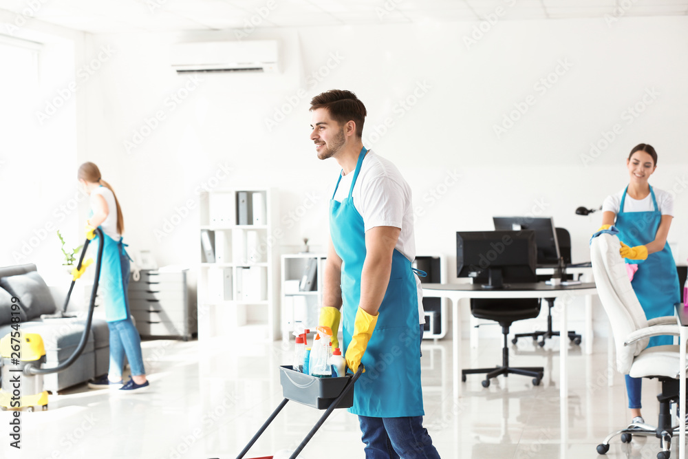Team of janitors cleaning office