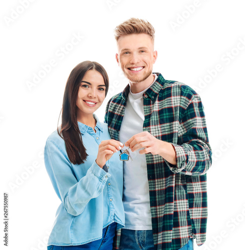Cuadros en Lienzo Young couple with key from their new house on white background