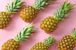 Many ripe pineapples on color background