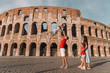 © travnikovstudio - Happy family in Europe. Parents and kids in Rome over Coliseum background
