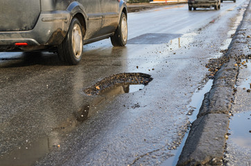 Big pothole on road after winter