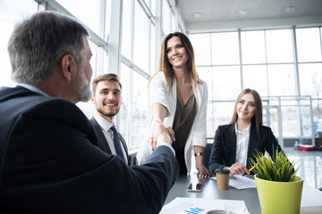 Wall Mural - Business people shaking hands while working in the creative office