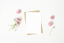 Feminine Stationery, Desktop Mock-up Scene. Vertical Blank Greeting Card, Craft Paper Envelope And Daisy Bouquet And Flowers Isolated On White Table Background. Flat Lay, Top View. Rustic Composition.